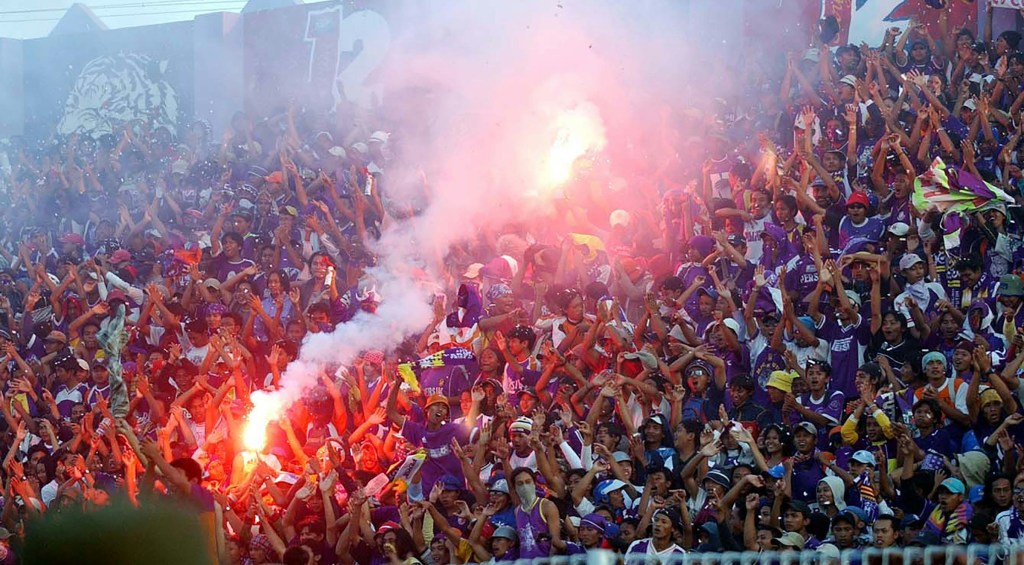 The action of football supporters in Malang, East Java, Indonesia named Arema celebrating at the Gajayana Stadium, Malang, Indonesia